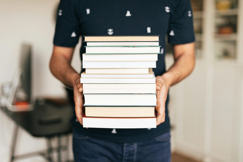 man holding books